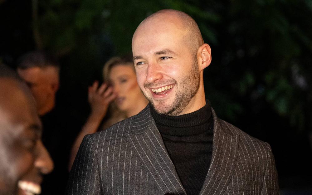 Aaron Watson laughing with friends at an evening event in Liverpool